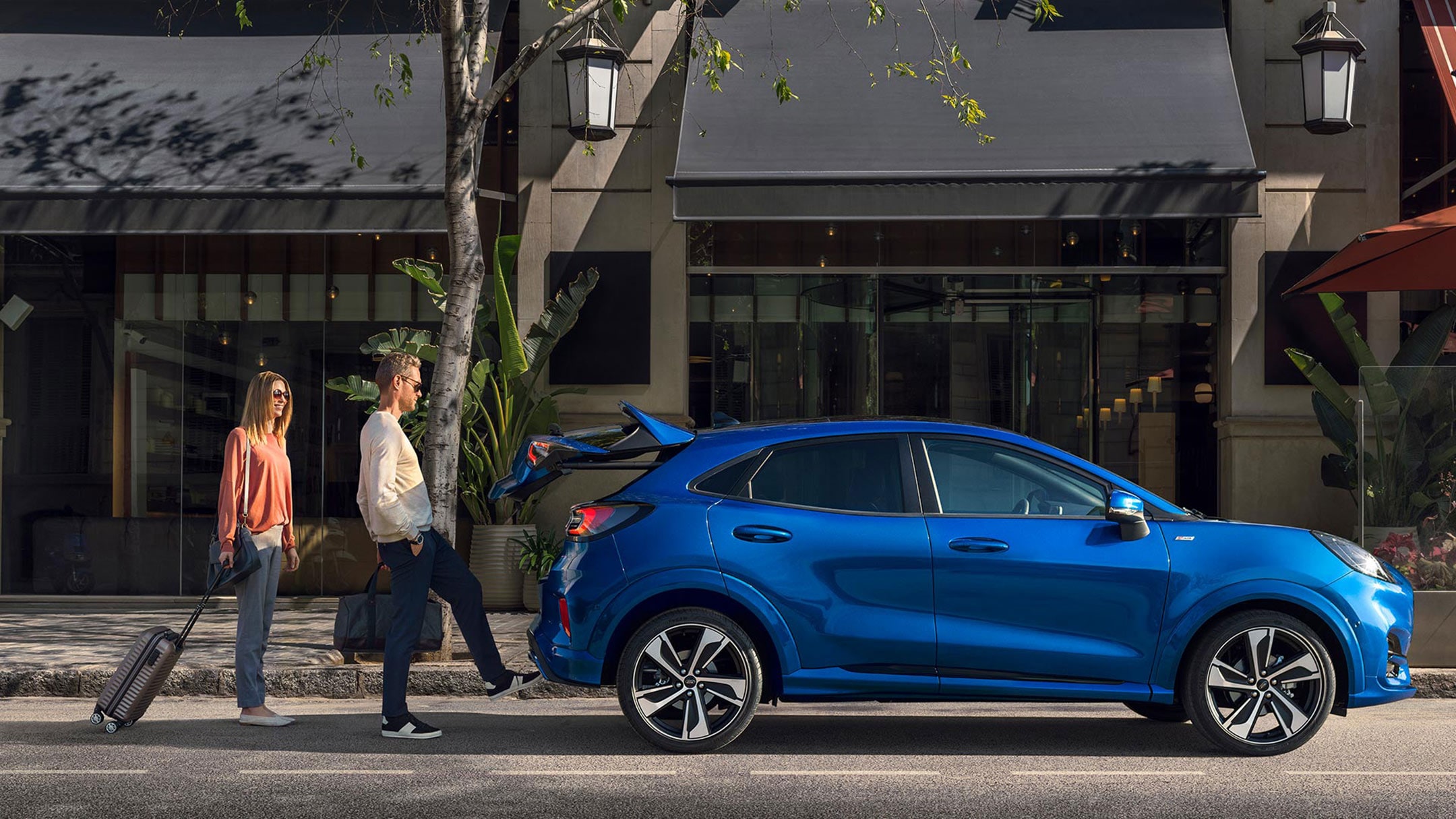 Couple giving bags in Ford Car