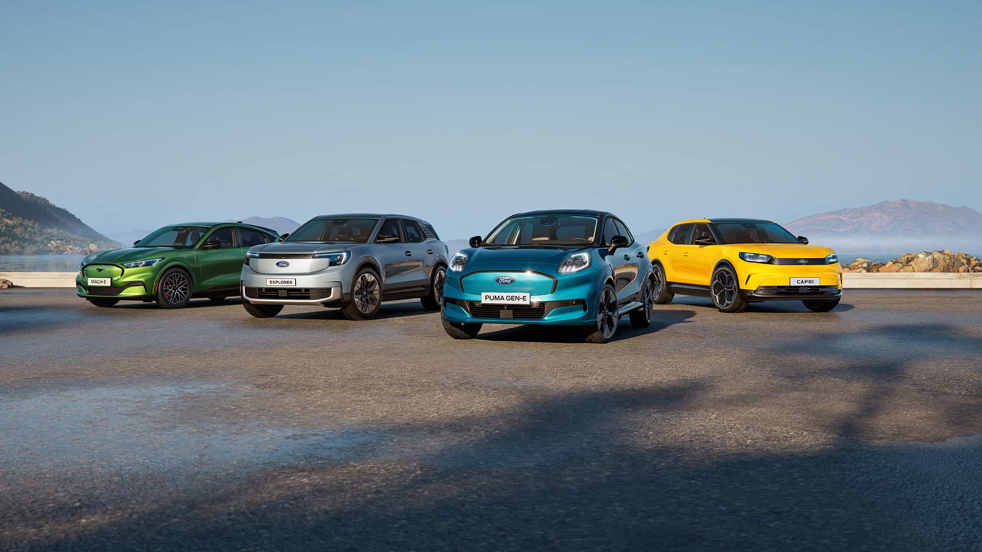 Vier Ford voertuigen opgesteld op een natte landingsbaan onder een blauwe hemel.