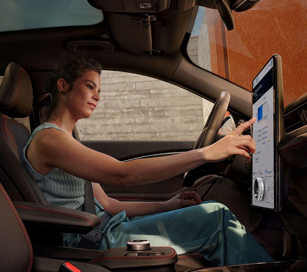Ford Mustang Mach-E interior view of woman using SYNC 4