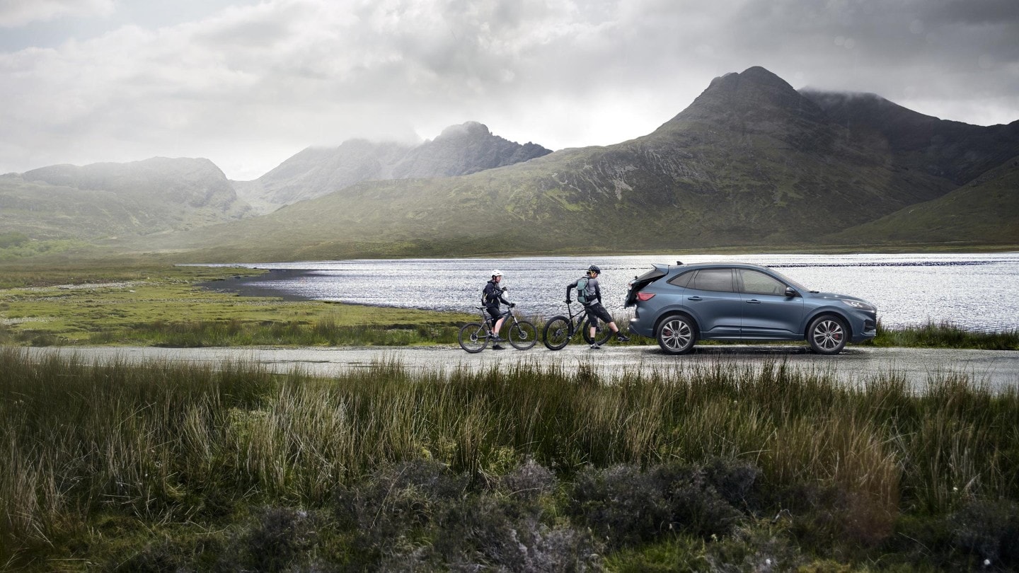 Woman using the Kuga hands-free tailgate