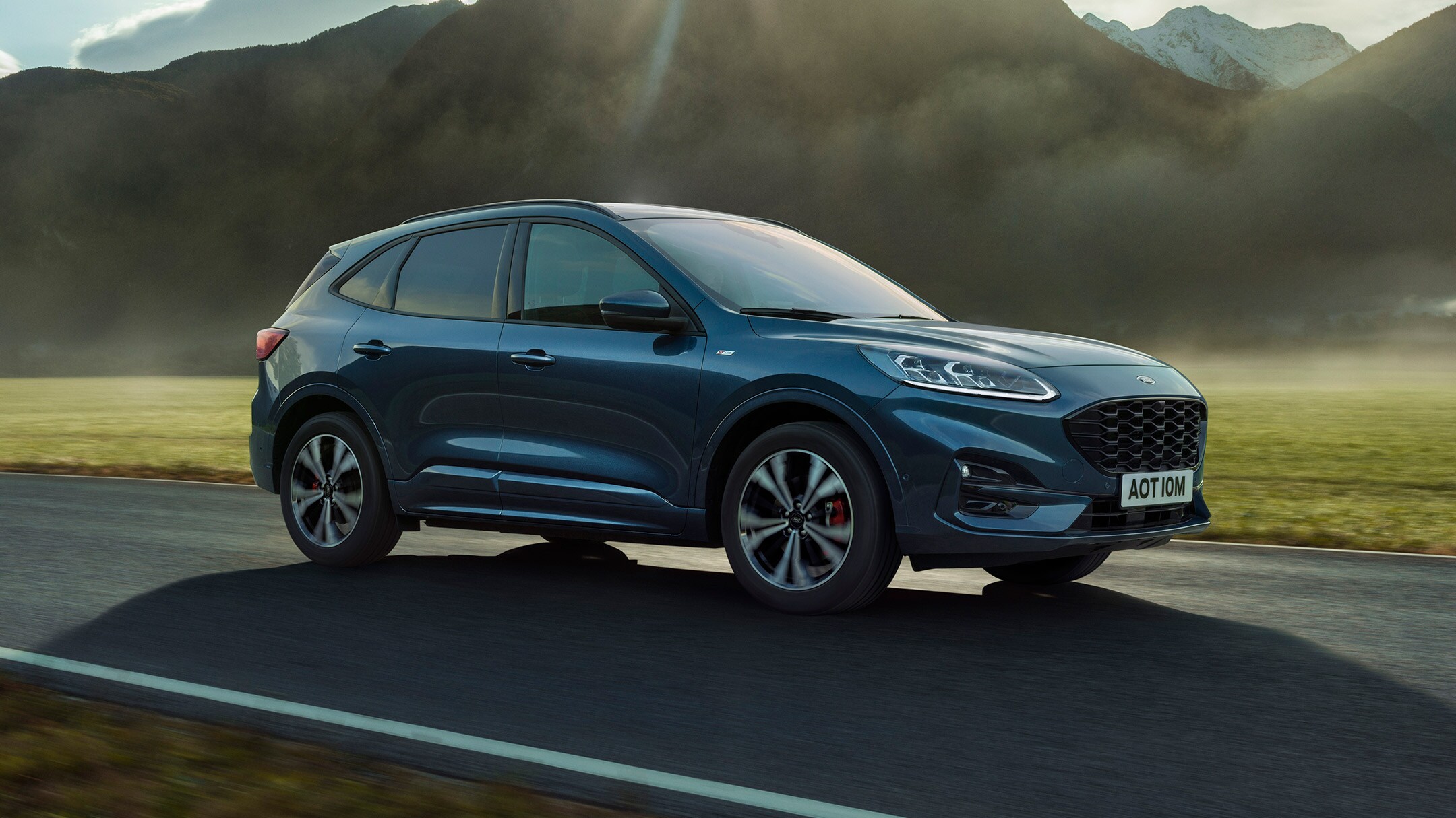 Ford Kuga Hybrid ST-Line X driving past mountains