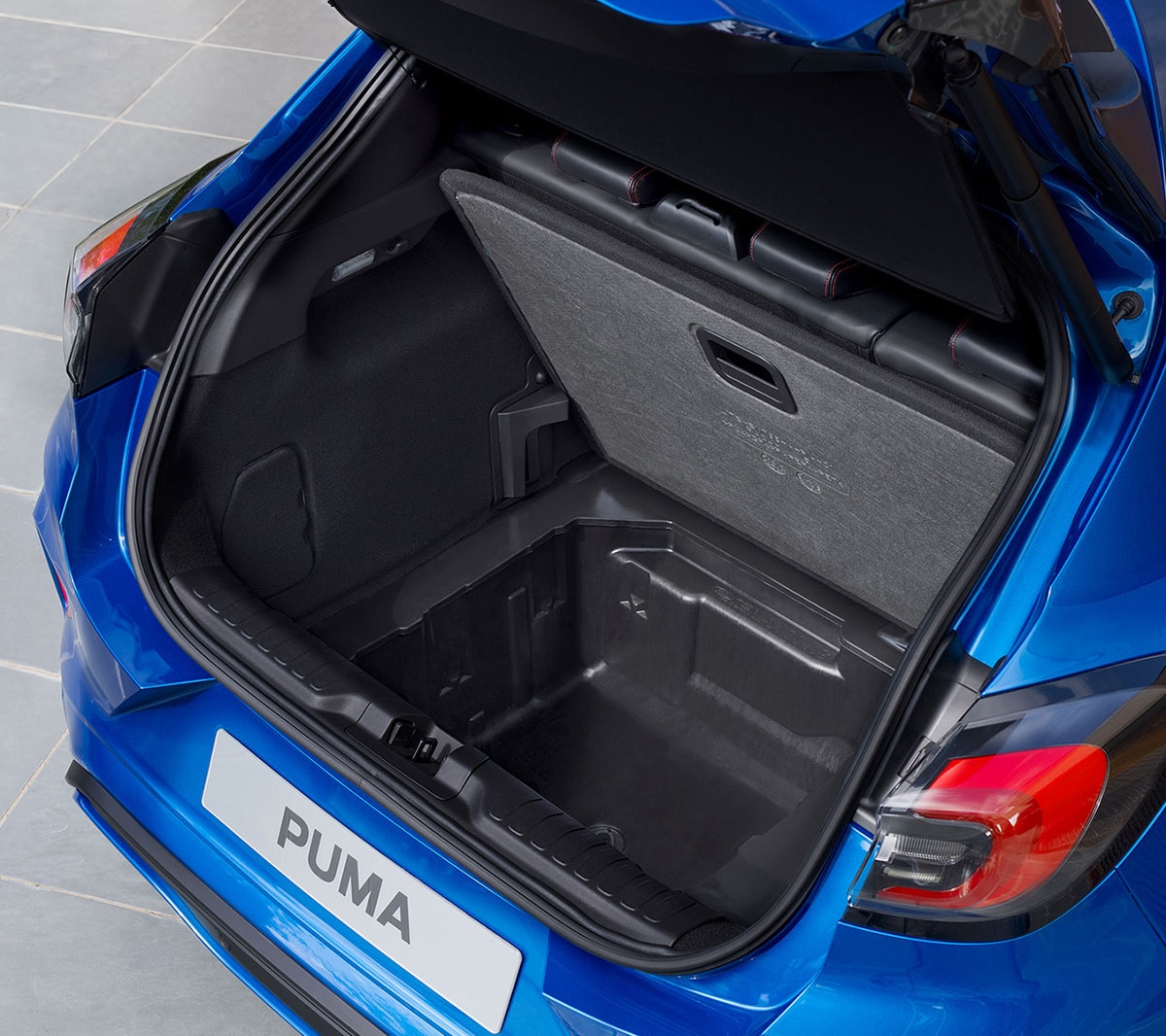 Blue Ford Puma rear view with open boot