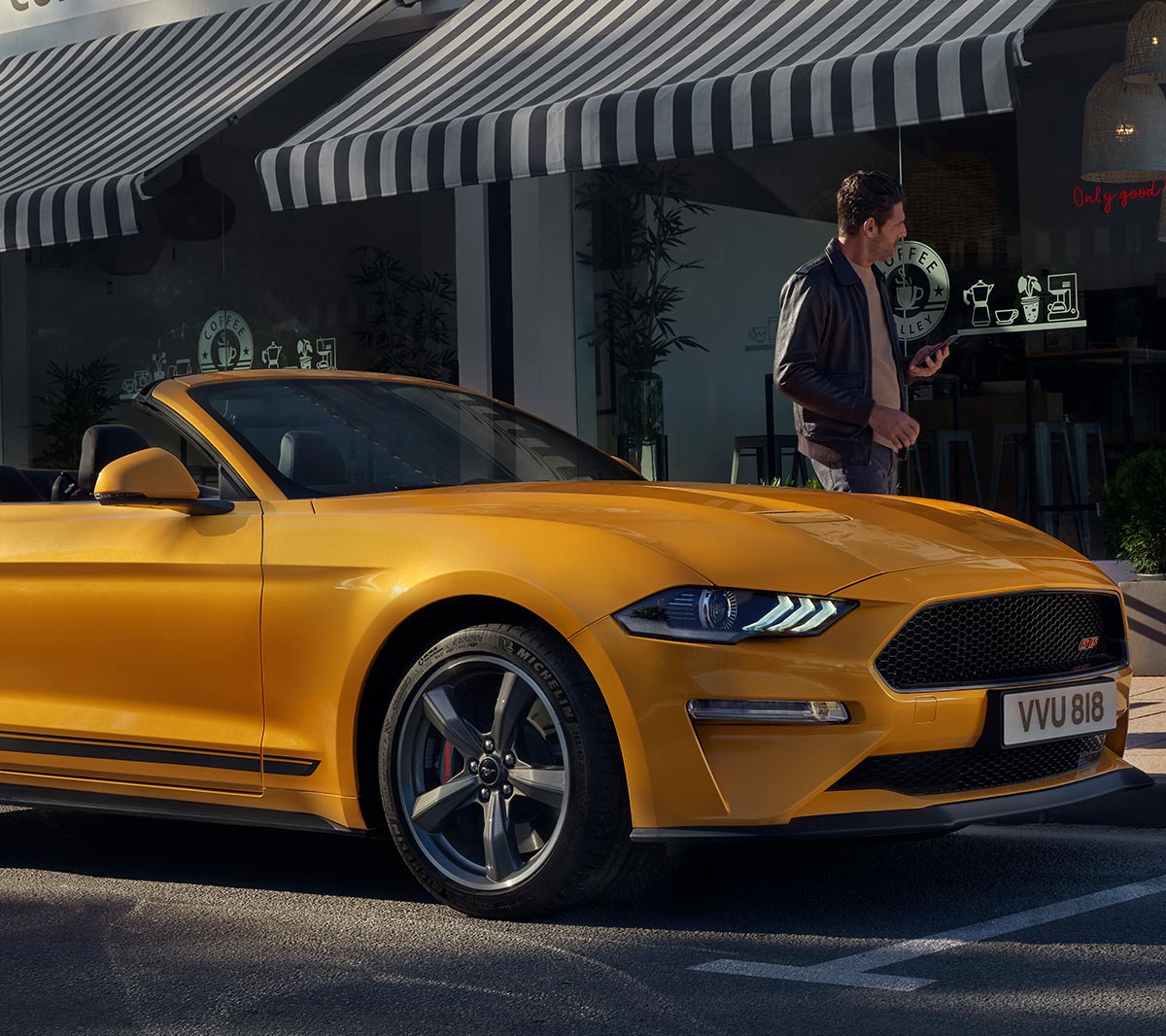 Ford Mustang California Edition parked in front of a coffee shop.