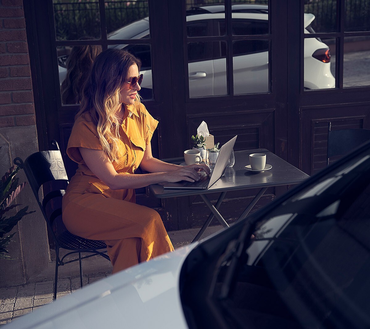 Ford Fiesta with woman sitting outside cafe