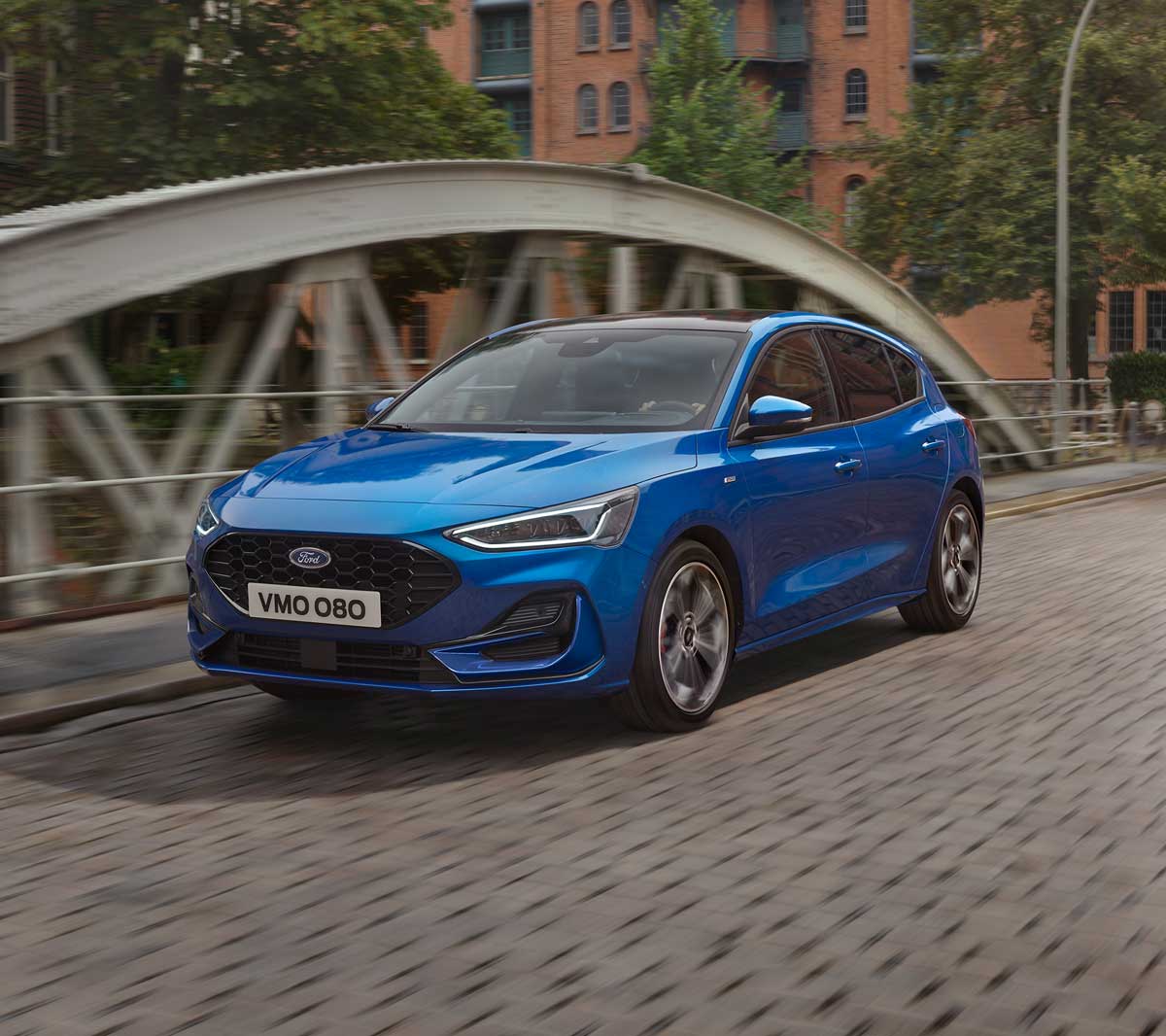 New Blue Ford Focus driving on a bridge