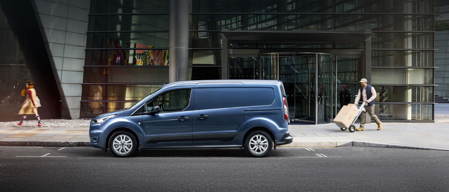 New Blue Ford Transit Connect driving in city