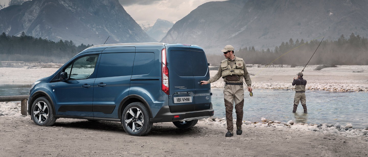 Ford Transit Connect with fisherman in countryside with mountains and lake