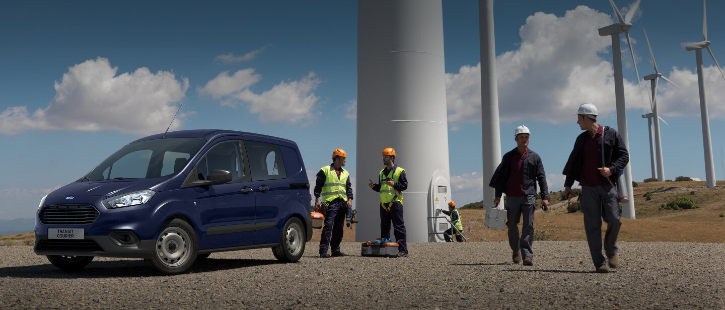 Dark Blue Ford Transit Custom Parked with workmen in high vis jackets