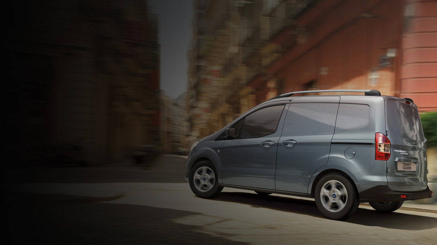 Blue Ford Transit Courier on highway