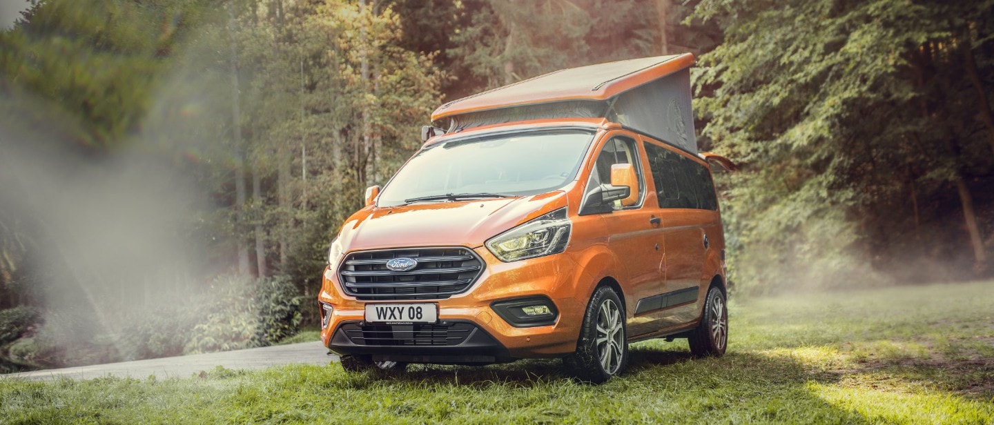 Ford Transit Custom Nugget parked in forest Ford Transit Custom Nugget parked in forest