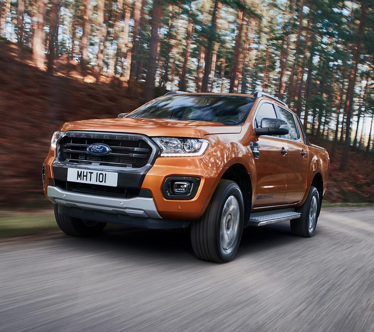 Orange Ford Ranger driving on road