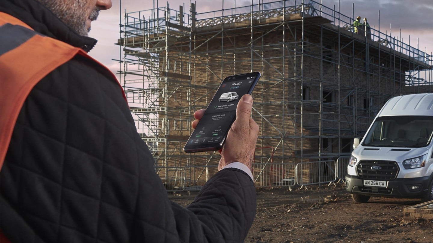 man using FordPass Pro on building site