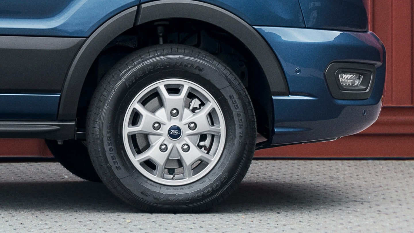 Blue Ford Transit Van front wheel close up