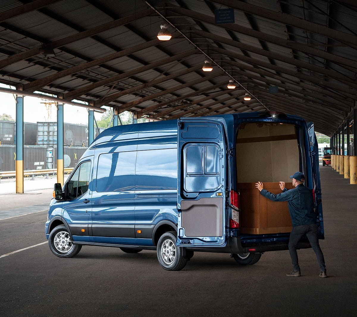 New Blue Transit Van rear view with man loading