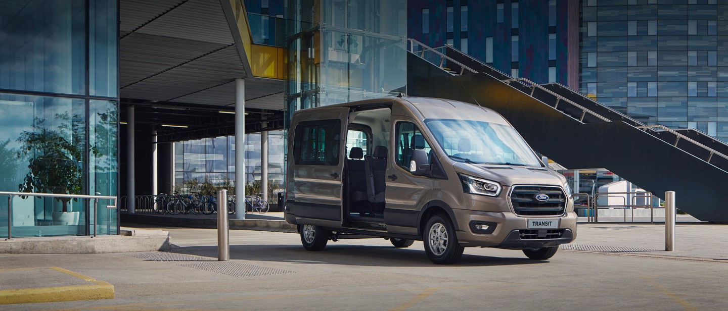 Ford Transit Kombi parking in front of modern building