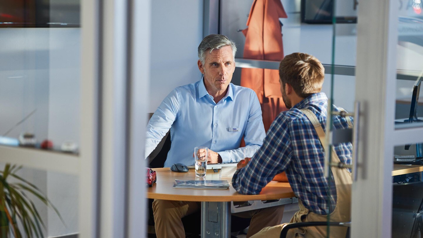 Two people discussing at the table