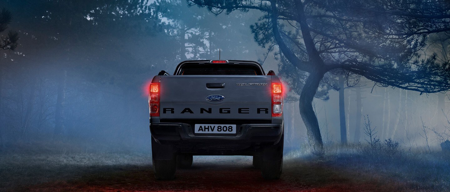 Rear view of a Ford Ranger Wolftrak parked in the woods