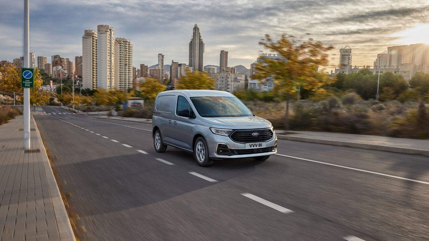 All-New Ford Transit Connect in SDe nieuwe Ford Transit Connect in Stardust Silver rijdt over een weg.tardust Silver drives along a road.