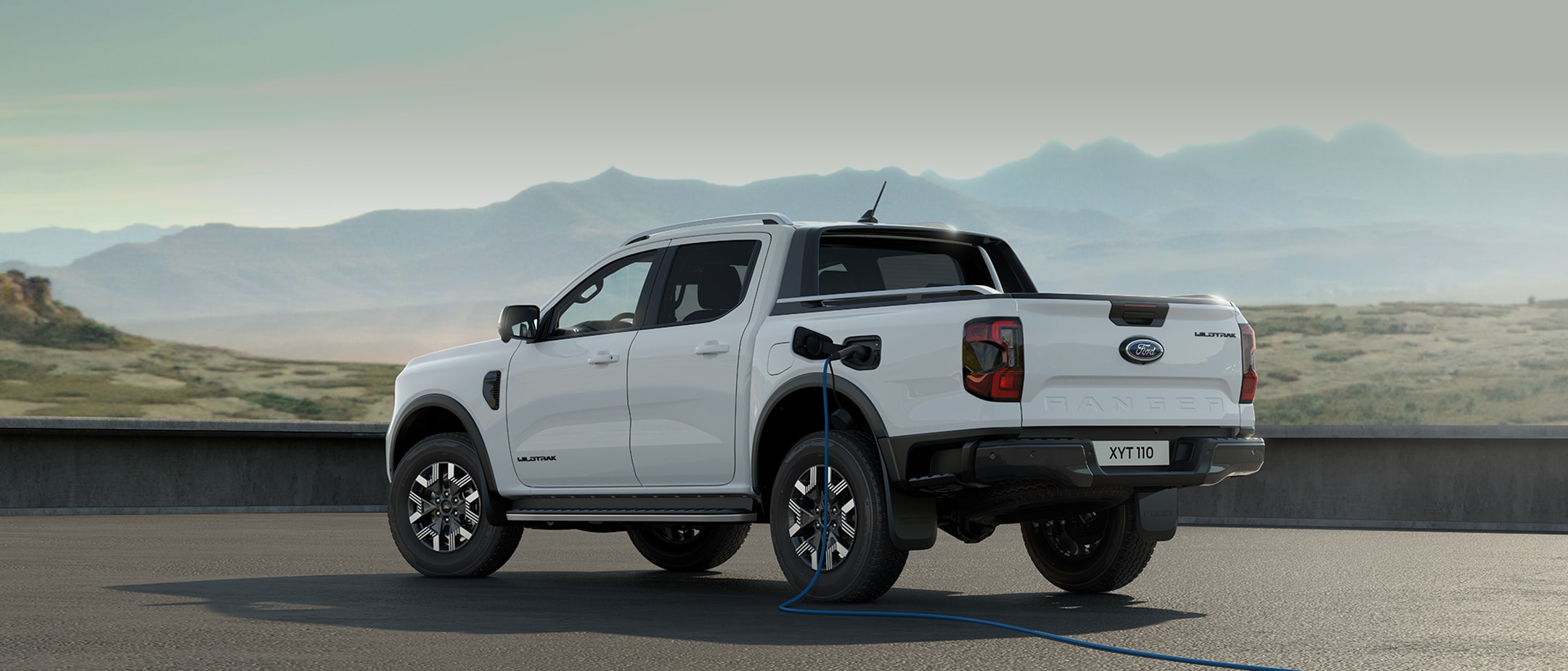White All-New Ranger Plug-in Hybrid being charged rear view