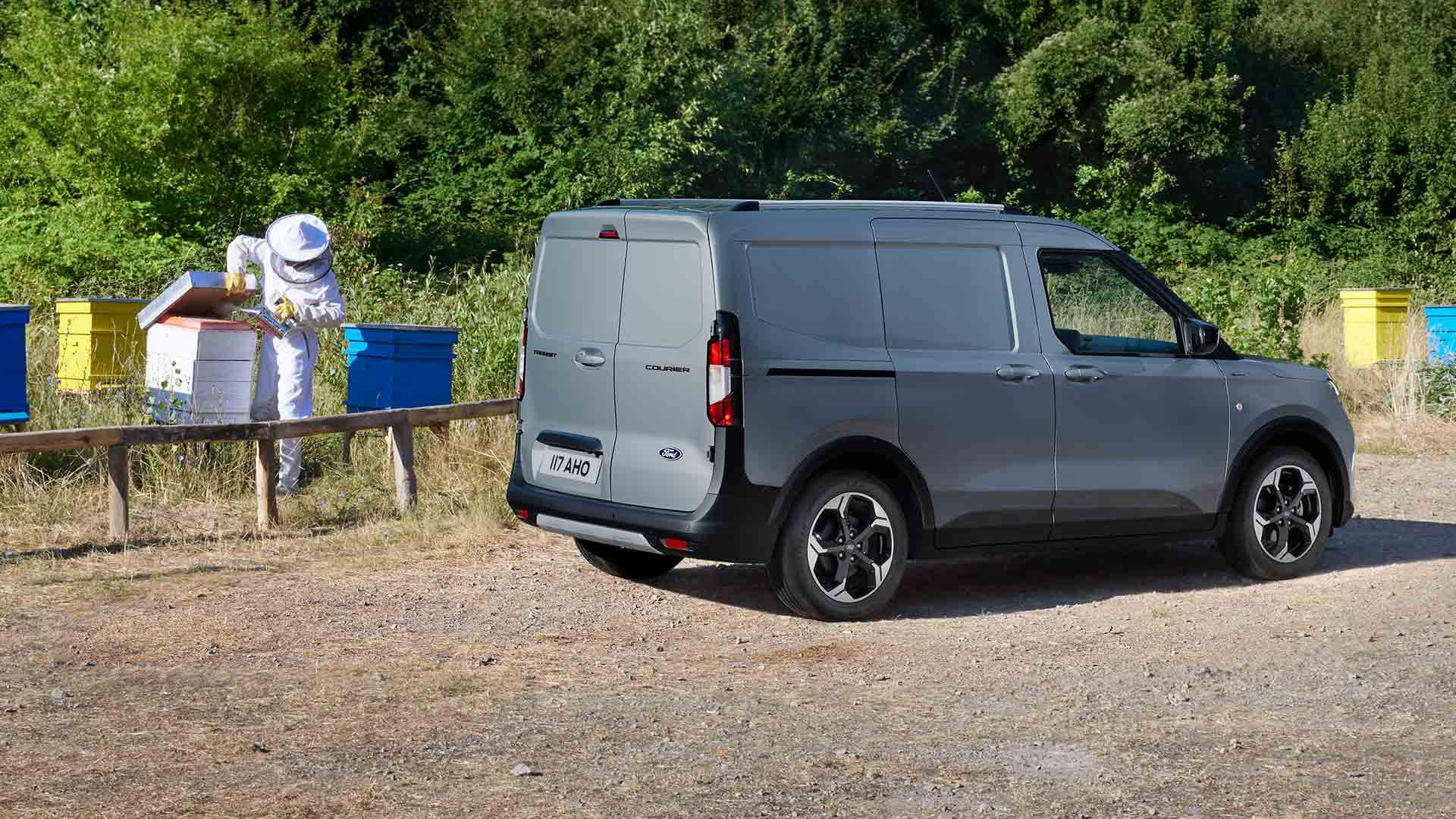 Imker aan het werk naast een Ford Transit Courier.