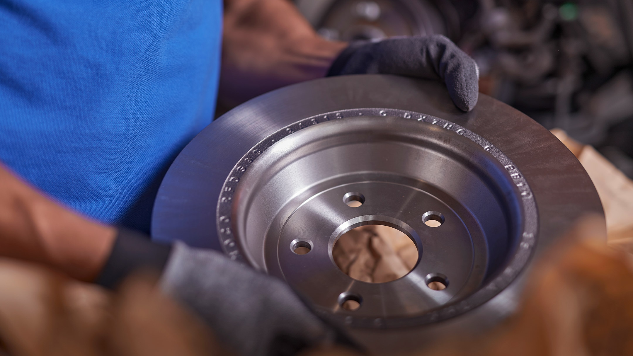 Een monteur houdt een origineel Ford-onderdeel vast tijdens een Ford-onderhoudsbeurt.