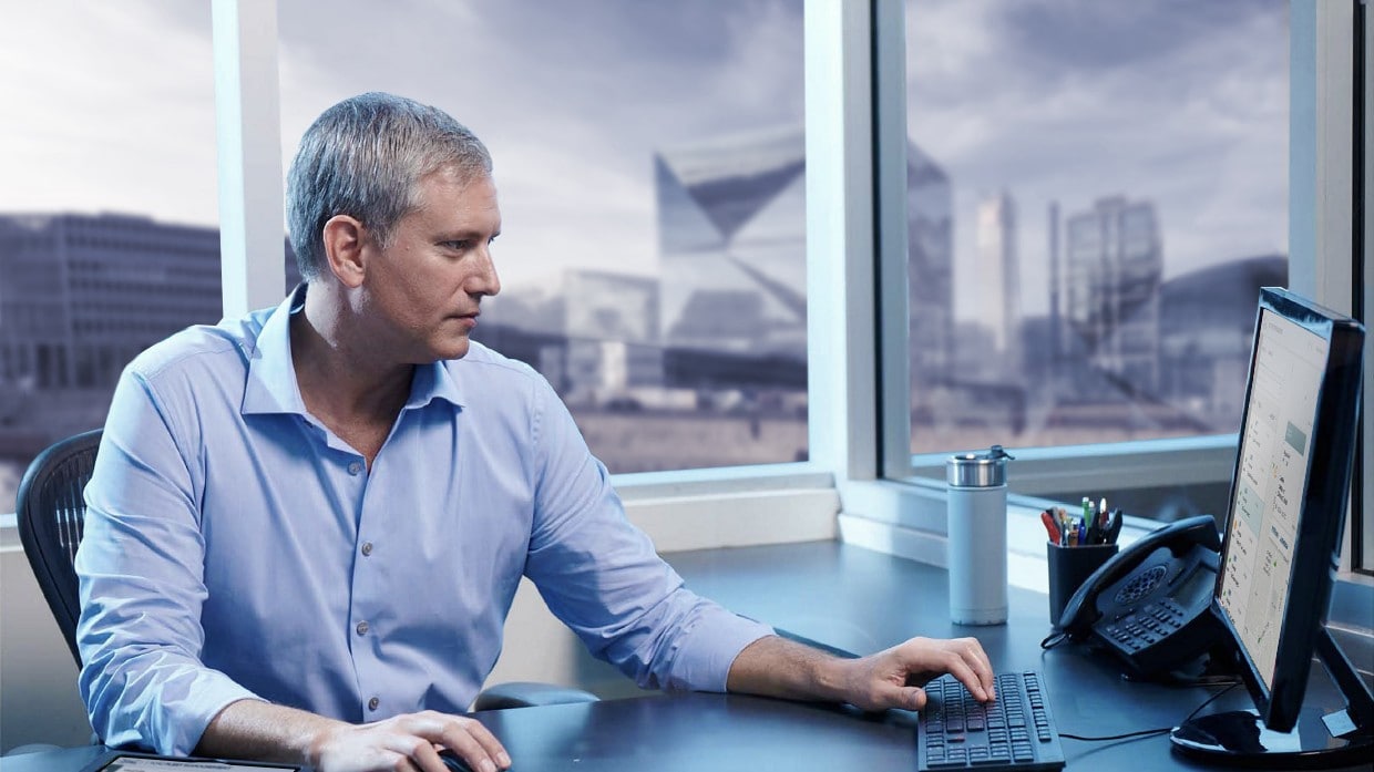 man in office in front of computer